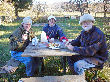 Bob and the aniversary couple enjoy a cool snack on the picnic table.